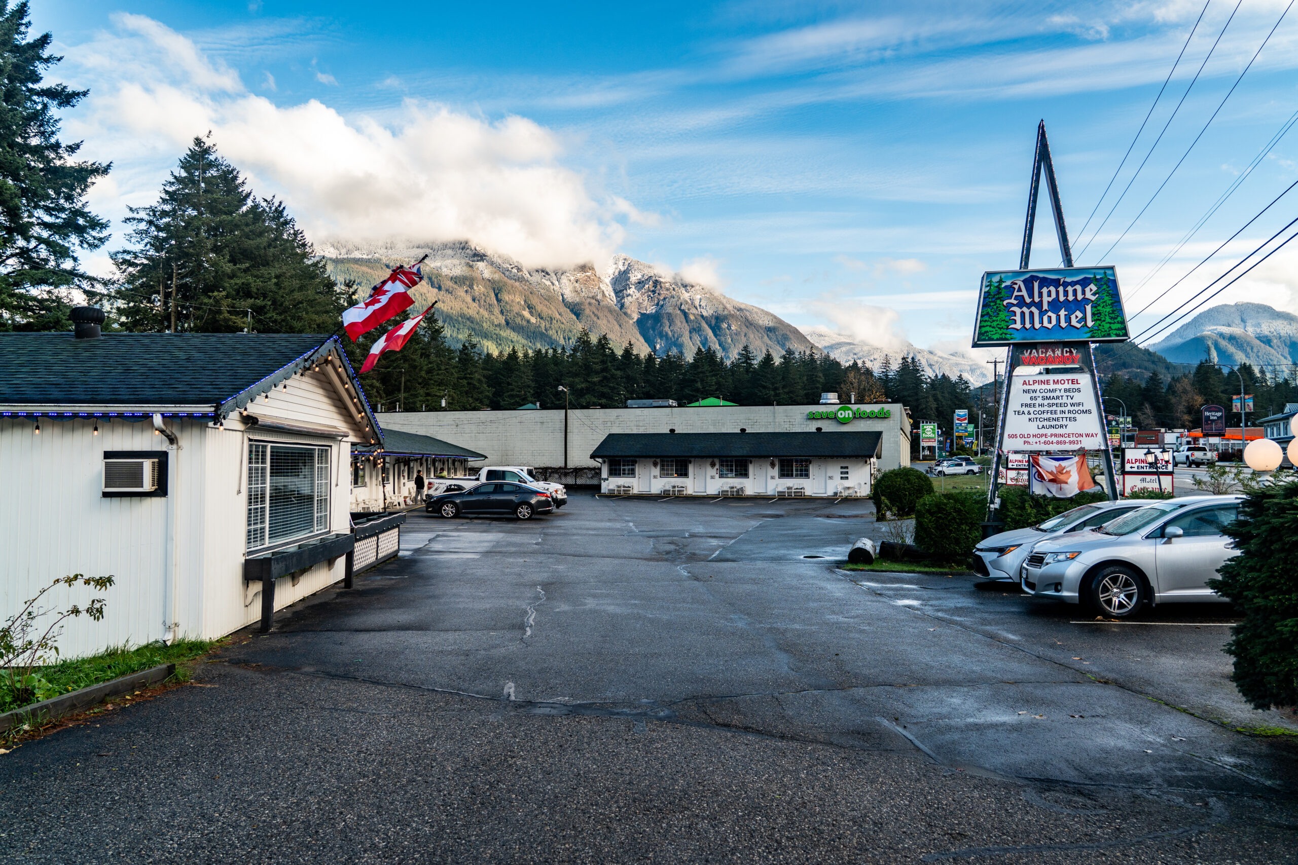 Alpine Motel property with mountain views and roadside sign